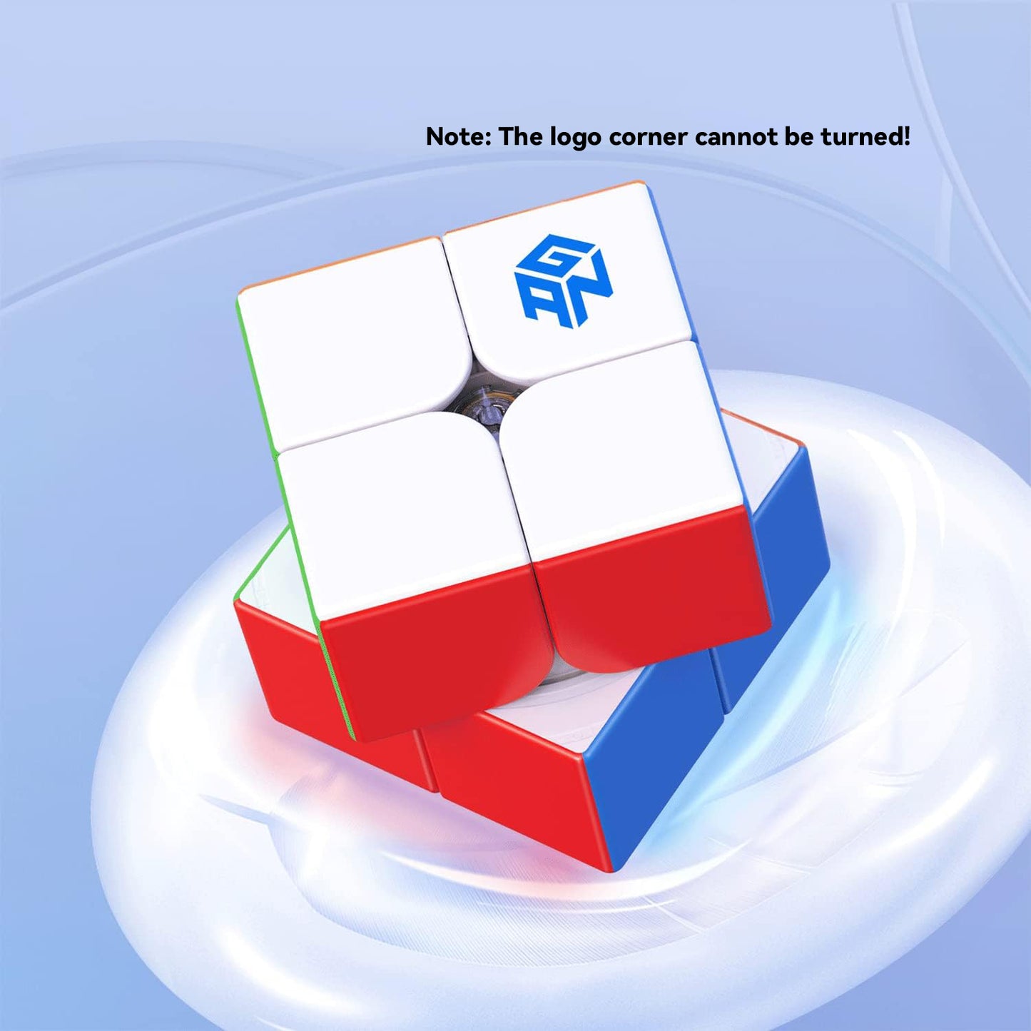 White and red GANCube 2x2 puzzle cube with logo on white tile, rotating on a sleek blue background
