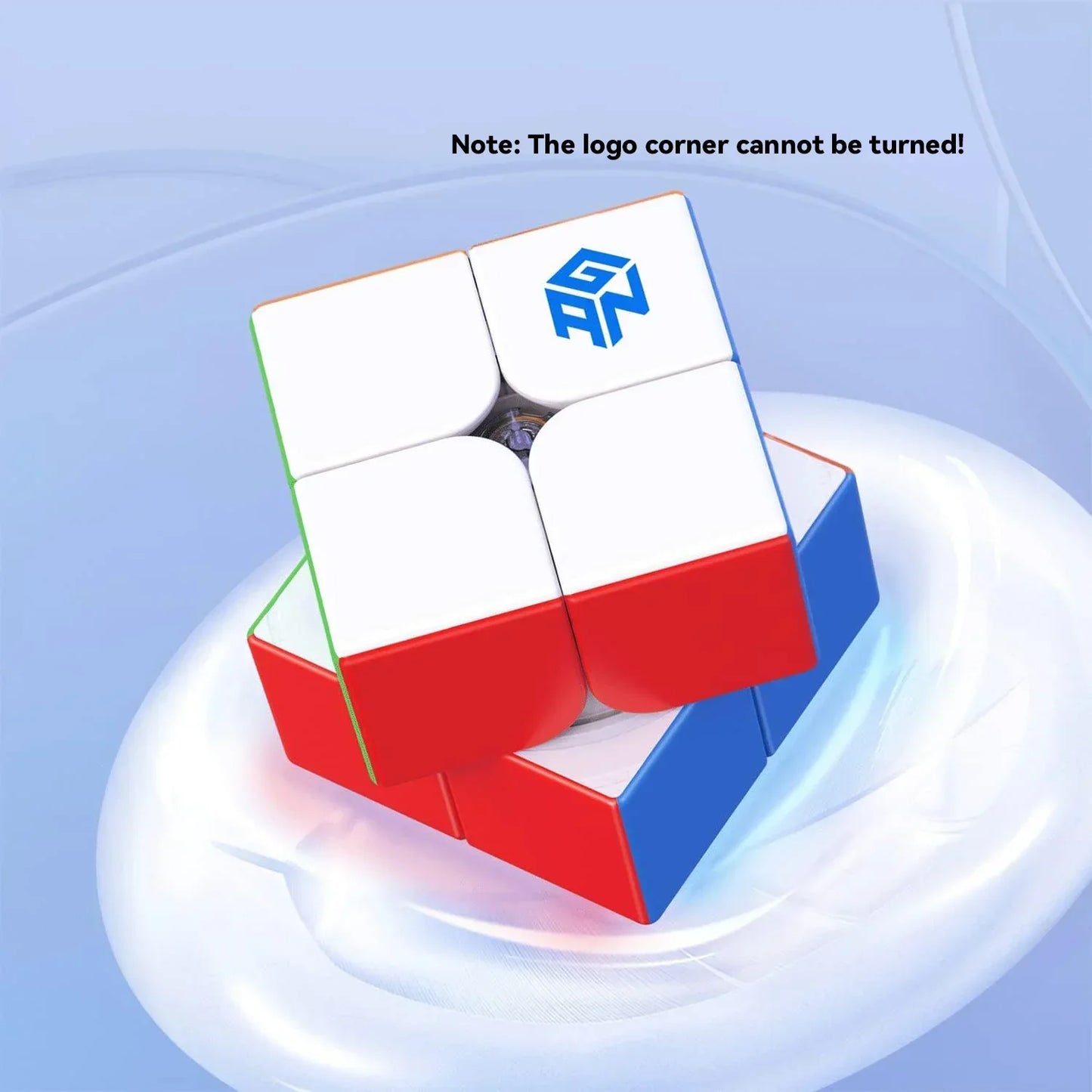 White and red GANCube 2x2 puzzle cube with logo on white tile, rotating on a sleek blue background