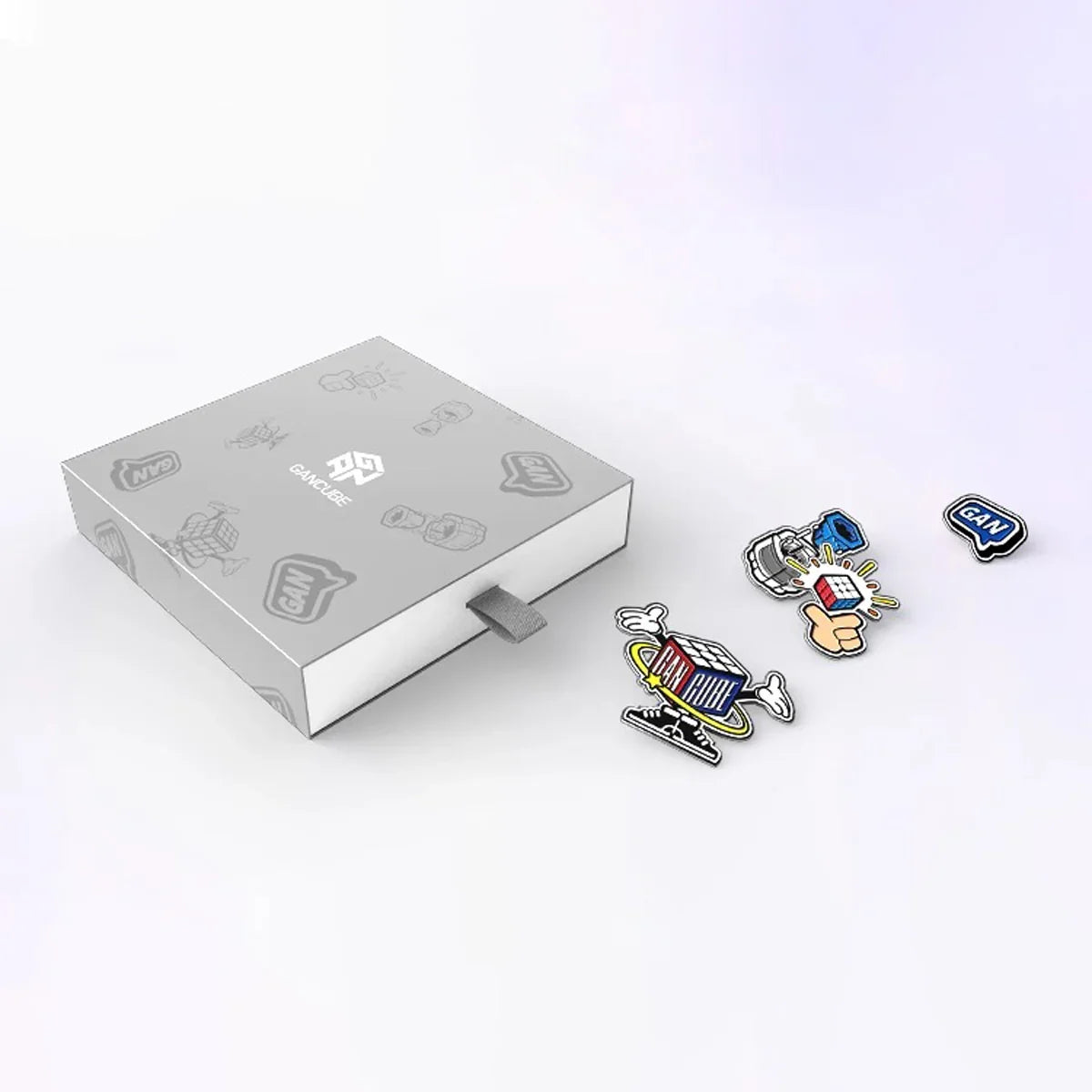 Gray GAN Cube gift box with four colorful stickers featuring Rubik's Cube and GAN logos on a white background