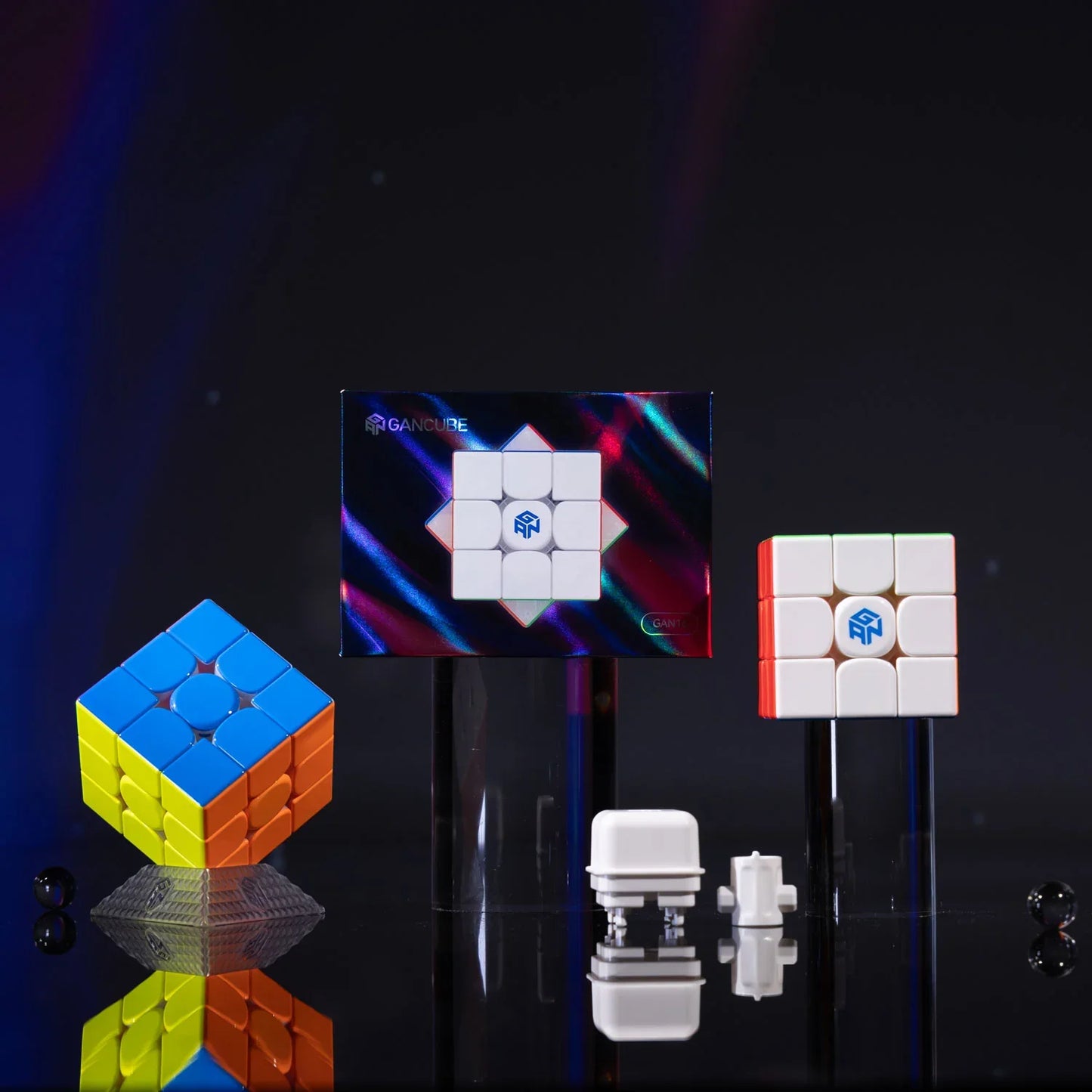 GAN 16 Maglev Max cube with colorful and white puzzle cubes and magnet parts on black reflective surface