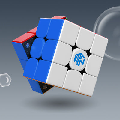 GanCube 356 Air M speed cube with white, blue, and red faces against gray background with bubbles