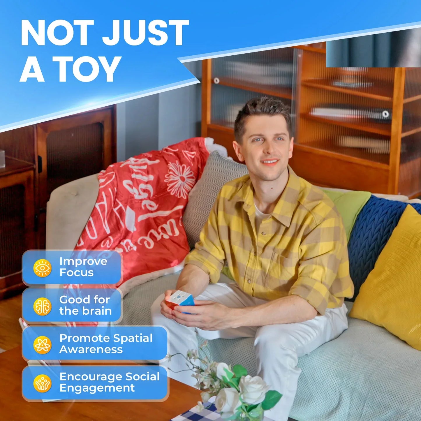 Young man sitting on couch holding a puzzle cube with text about focus, brain, spatial awareness, social engagement