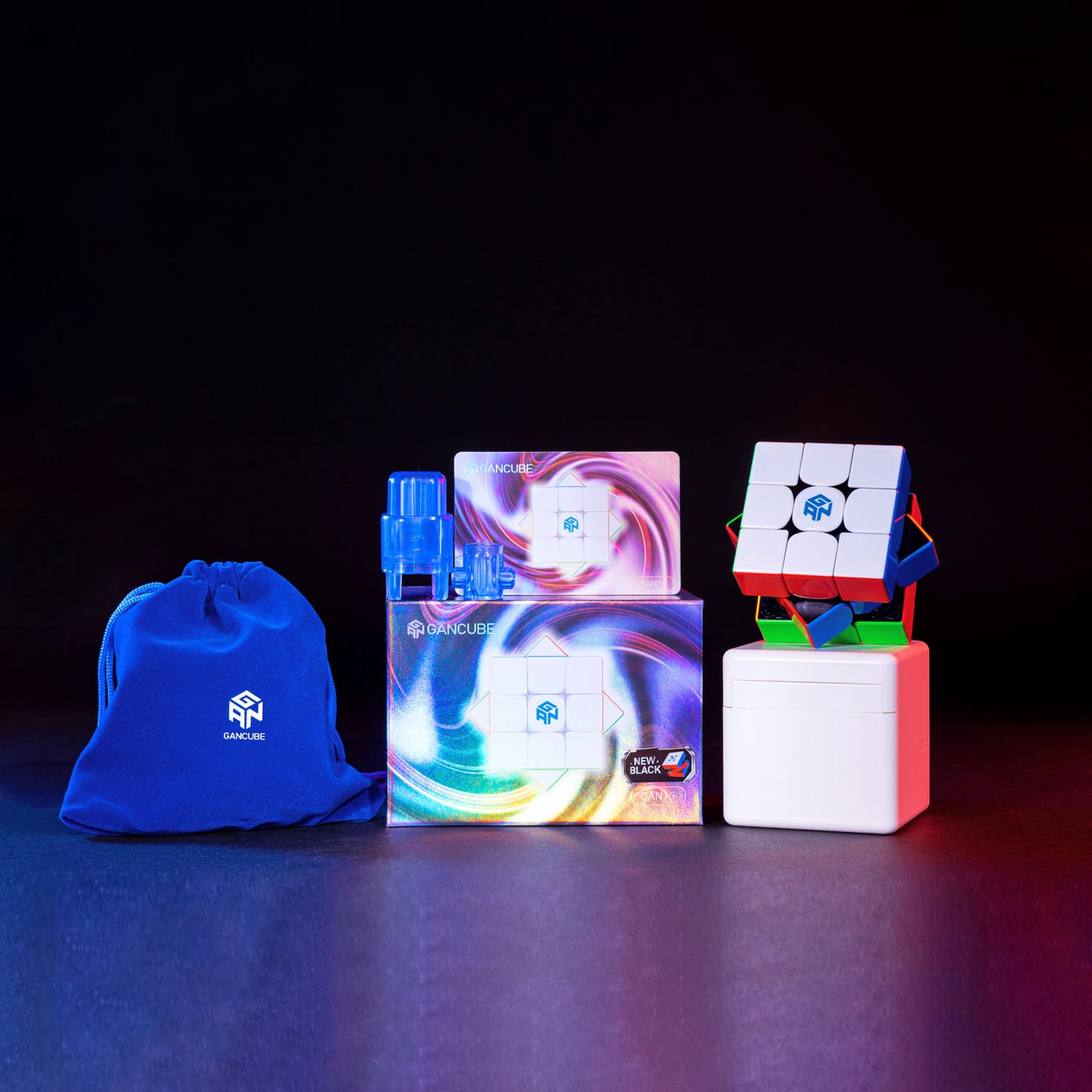 GanCube GAN 15 Leap black speed cube set with branded blue pouch, accessories, and packaging on dark background