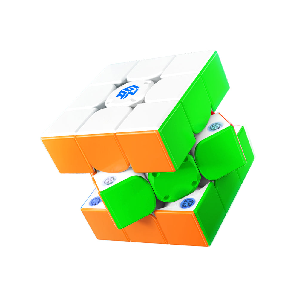 3x3 speed cube puzzle partially twisted with visible green, orange, and white stickers and blue GANCube logo
