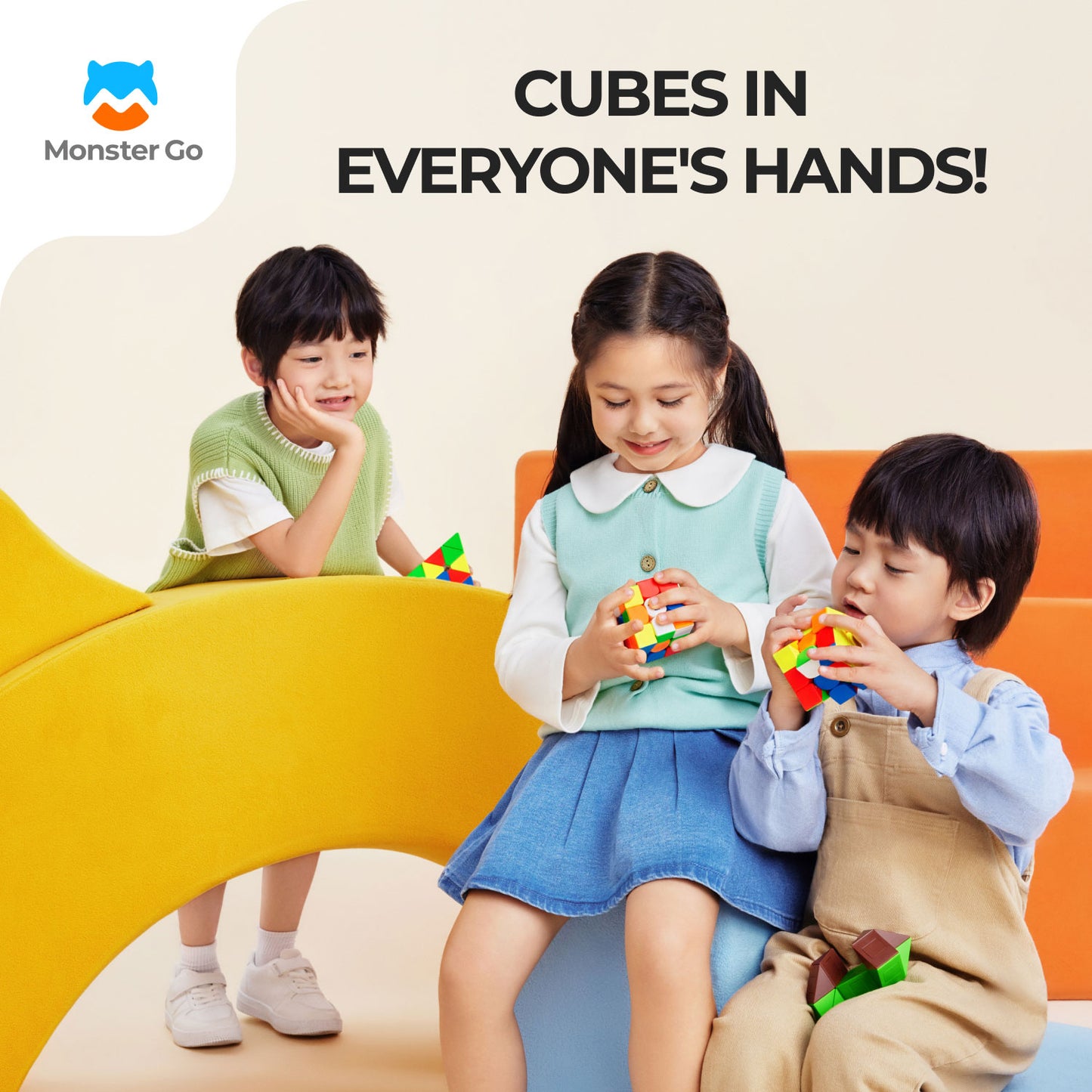 Three children playing with colorful magnetic cubes on modern yellow and orange furniture