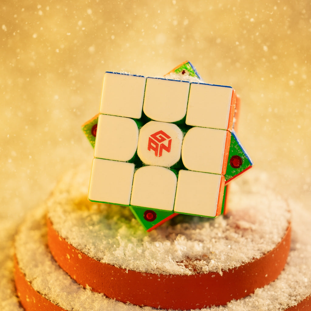 Gan 356 ME Rubik's Cube in winter snow scene on orange circular platform
