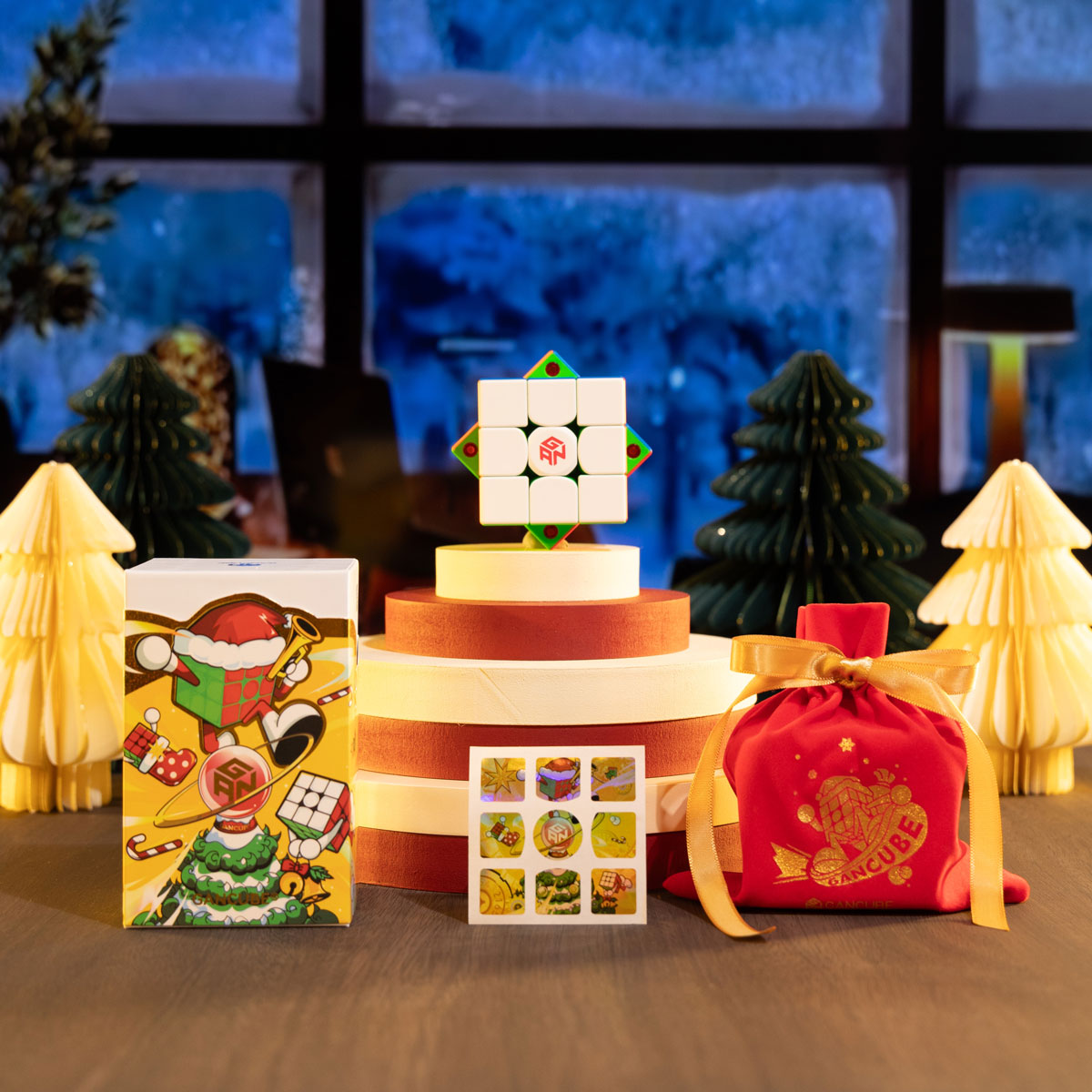 Christmas-themed GanCube puzzle setup with festive packaging, stickers, and decorative holiday trees