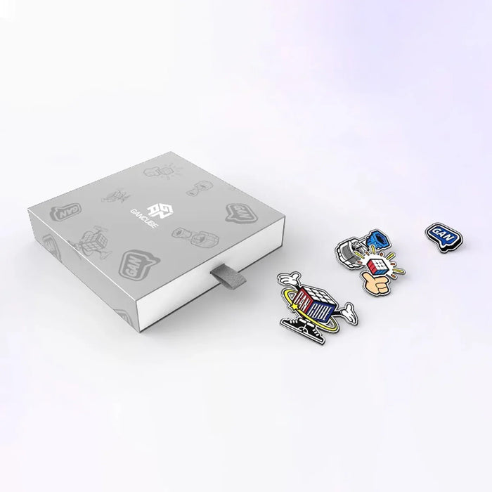 Gray GAN Cube gift box with four colorful stickers featuring Rubik's Cube and GAN logos on a white background
