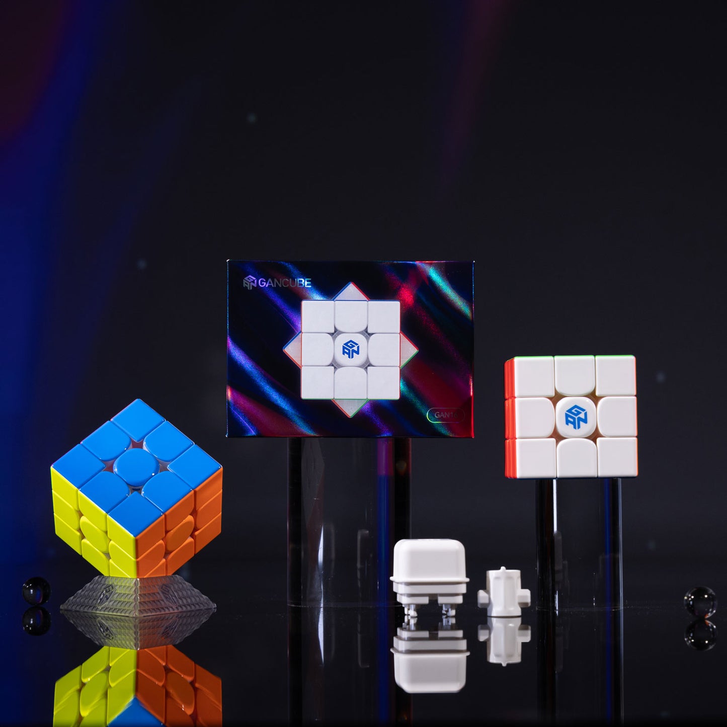GAN 16 Maglev Max cube with colorful and white puzzle cubes and magnet parts on black reflective surface