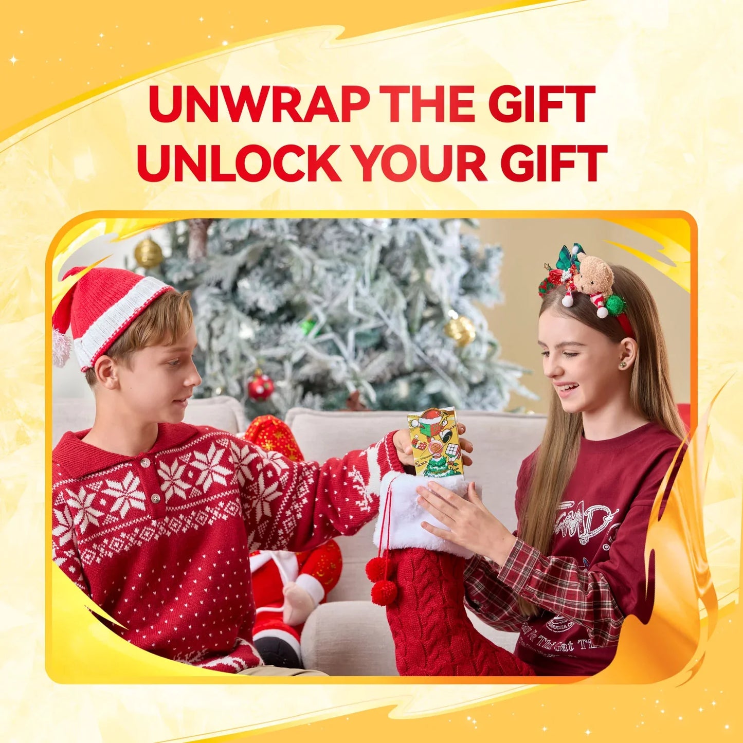 Two kids in Christmas outfits exchanging a gift in front of a decorated Christmas tree