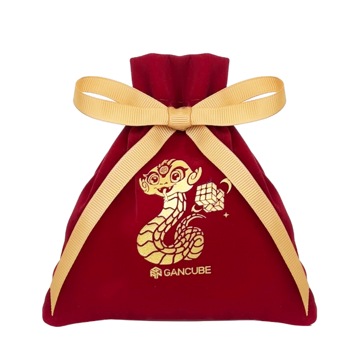 Red velvet drawstring bag with gold ribbon and golden snake and Rubik's cube design, GanCube logo