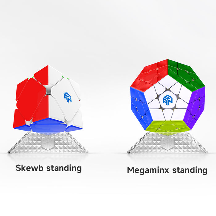 Two standing GAN twisty puzzles on triangle-shaped clear plastic stands: a Skewb and a Megaminx with multicolored faces