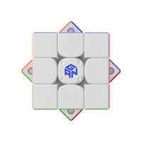 GAN speed cube with white face and blue logo, featuring colorful edge pieces and magnetic mechanism